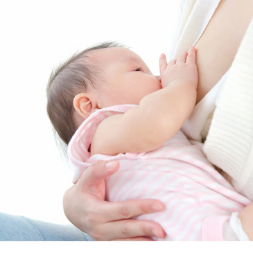 A baby breastfeeding, held gently by a caregiver.