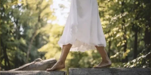 barefoot woman in forest — symbol of first steps, soul resonance, and emotional clarity