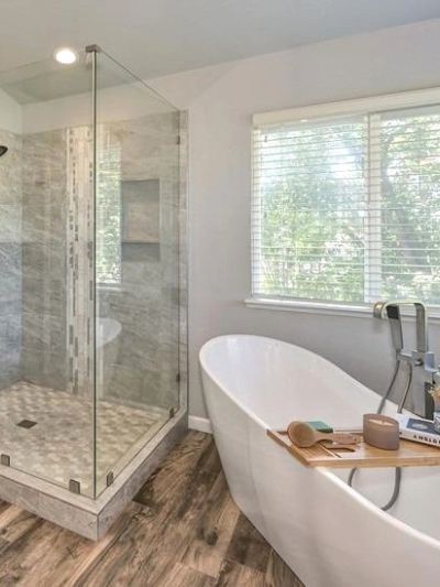 Modern bathroom with freestanding tub and glass shower.