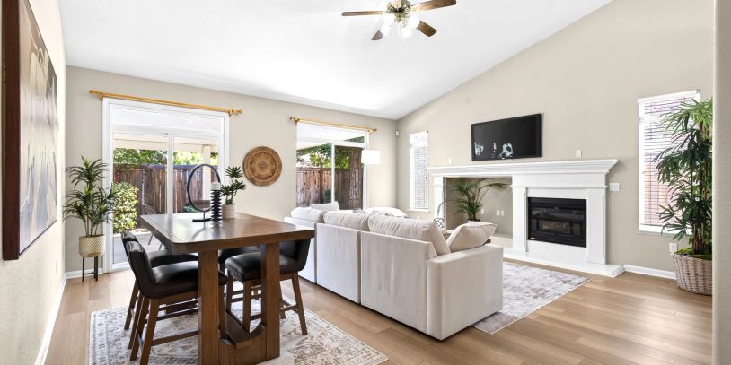 Bright living and dining area with neutral tones and wood accents.