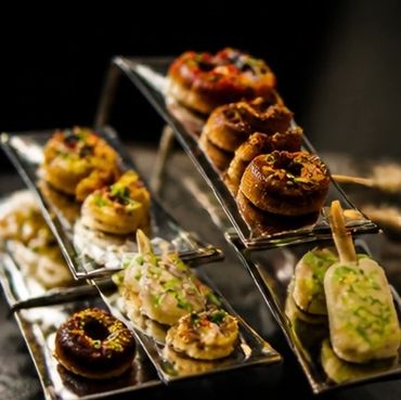 Assorted gourmet donuts and pastries displayed on elegant trays.