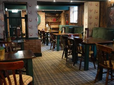 Empty cozy pub with wooden tables and chairs.