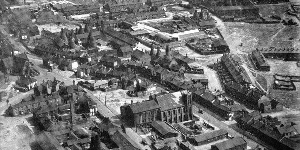 Aerial view of an industrial town with buildings and roads.
