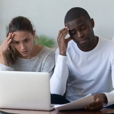 stressed couple looking at bills