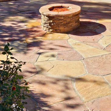 Stone fire pit with patterned stone patio.