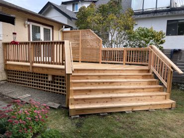 Newly built wooden deck with stairs and railing.