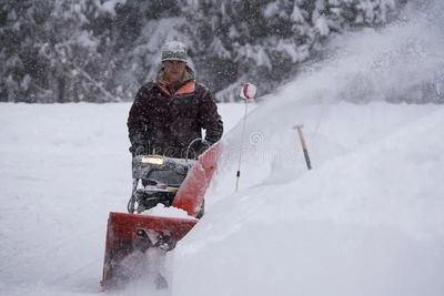 Man using a big snow blower
