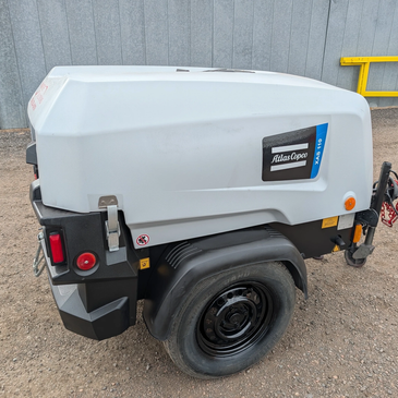 Portable Atlas Copco equipment on a wheel.