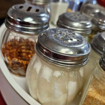 Image of Pepper and Cheese Dispensers at Pizza Phil