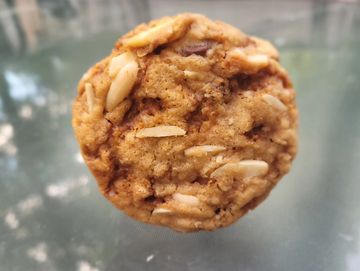 The eponymous Cookie with almond slivers against open air background