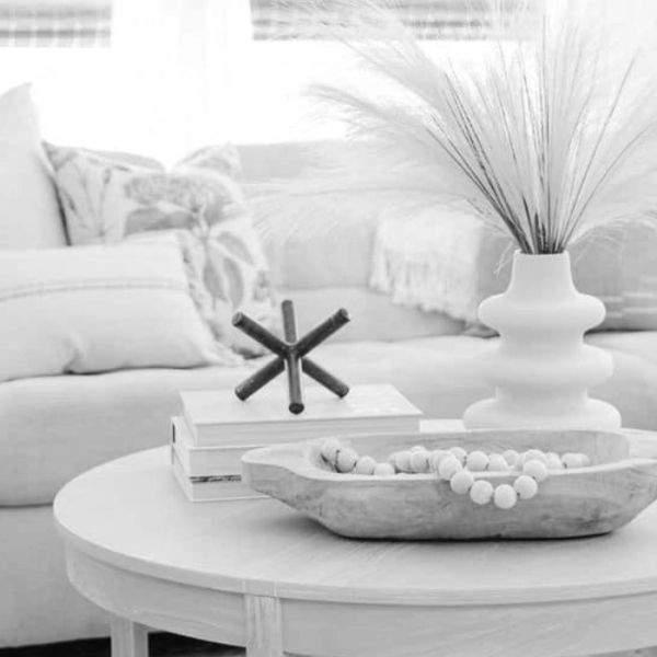 Minimalist living room with cozy sofa and decorative table.