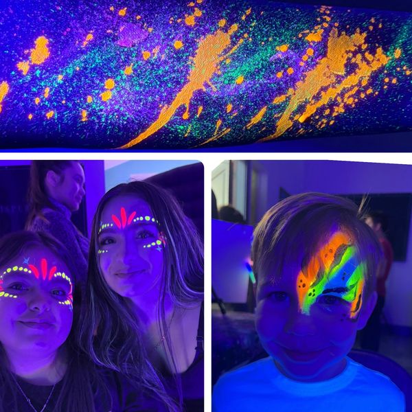 People with colorful UV face paint glowing under blacklight.