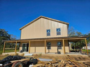 New two-story metal house under construction.