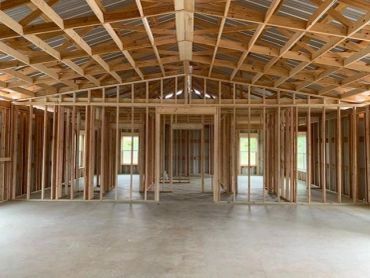 Interior of a house under construction showing wooden framing.