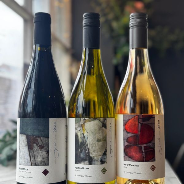 Three bottles of wine with artistic labels from St. Pentagh vineyard.