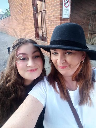 Mum and daughter dressed up and smiling