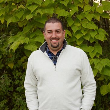 Ryan Harrell standing against a green wall.
