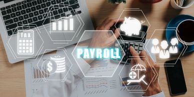 Person calculating payroll with financial icons overlay.