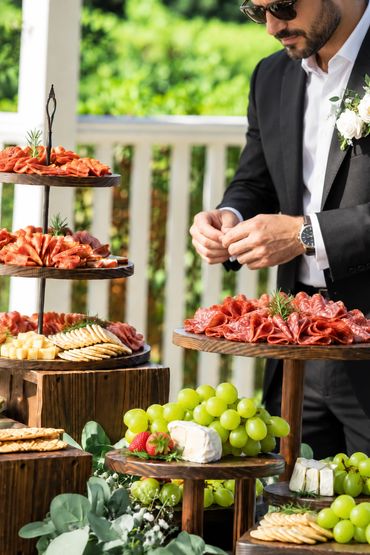 Man arranging meats on a buffet table.