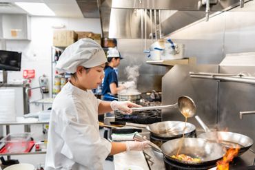 Chef cooking food in the kitchen of a restaurant