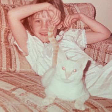 Whisker Station's owner, Sara, as a child with her first cat named Daisy.
