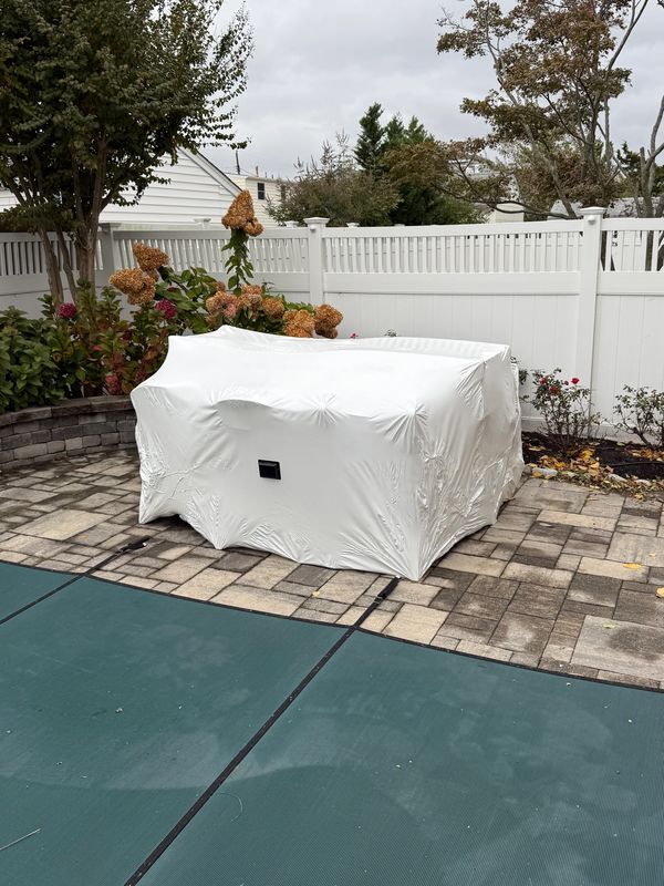 Outdoor furniture being protected over the off-season. 