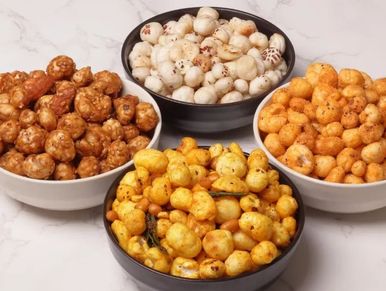 Four bowls of assorted flavored puffed snacks on a marble surface.