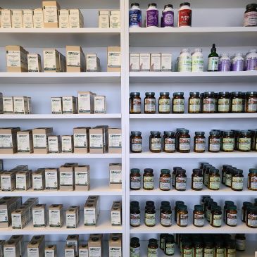 Shelves stocked with various health supplements and vitamins.