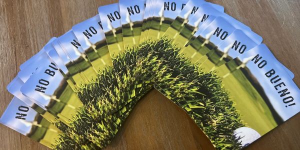 Fan of cards with a golf ball and grass, saying 'NO BUENO!'.
