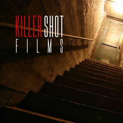 Dimly lit staircase leading up to a closed door with 'Killer Shot Films' text overlay.