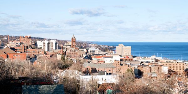 Growing city skyline representing practical Copilot benefits productivity gains for small businesses