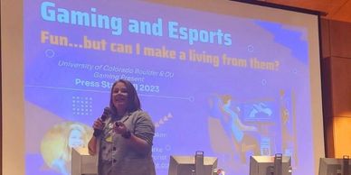 Presenter speaks on gaming and esports at a university event.