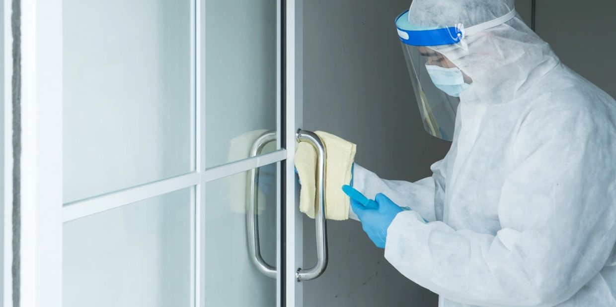 Workers wear protective clothing and wear a mask. Spraying disinfectants for cleaning 