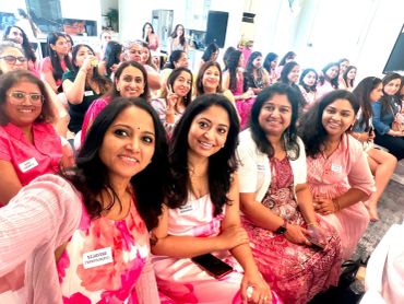 Group of women smiling at an event.