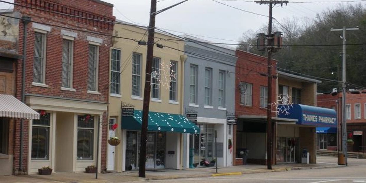 Historic brick storefronts line downtown Wetumpka’s main street, with a pharmacy