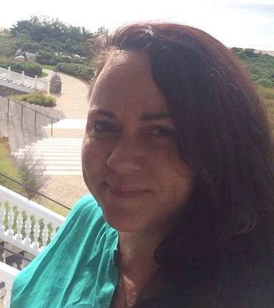 woman on balcony on St. John wearing a green shirt