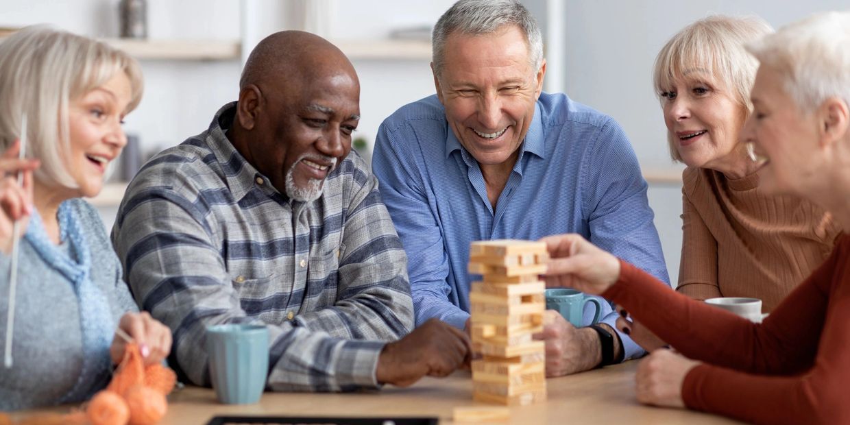 group of elderly people playing jenga