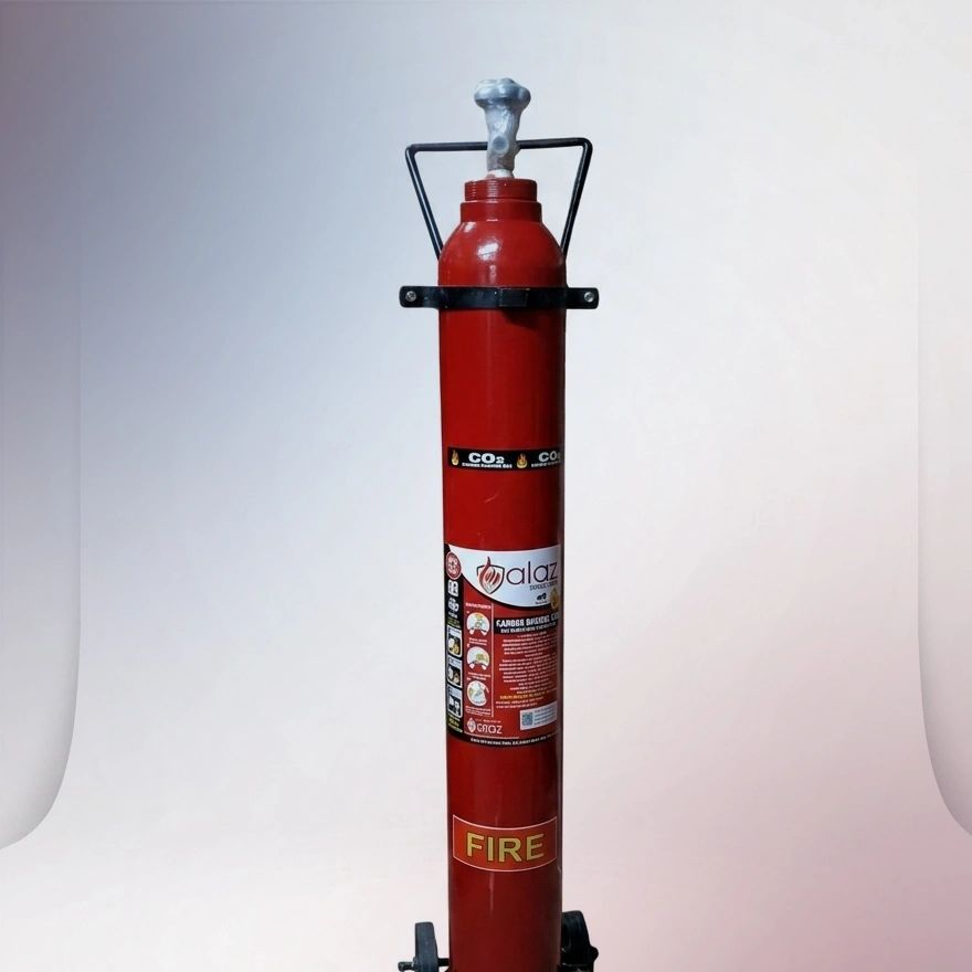 Alaz CO2 fire extinguisher with wheels and safety instructions.