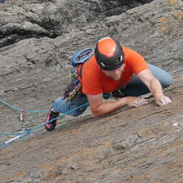 Climber on a rock climbing route in Pembroke