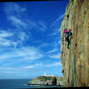 Climber leading a route in North Wales