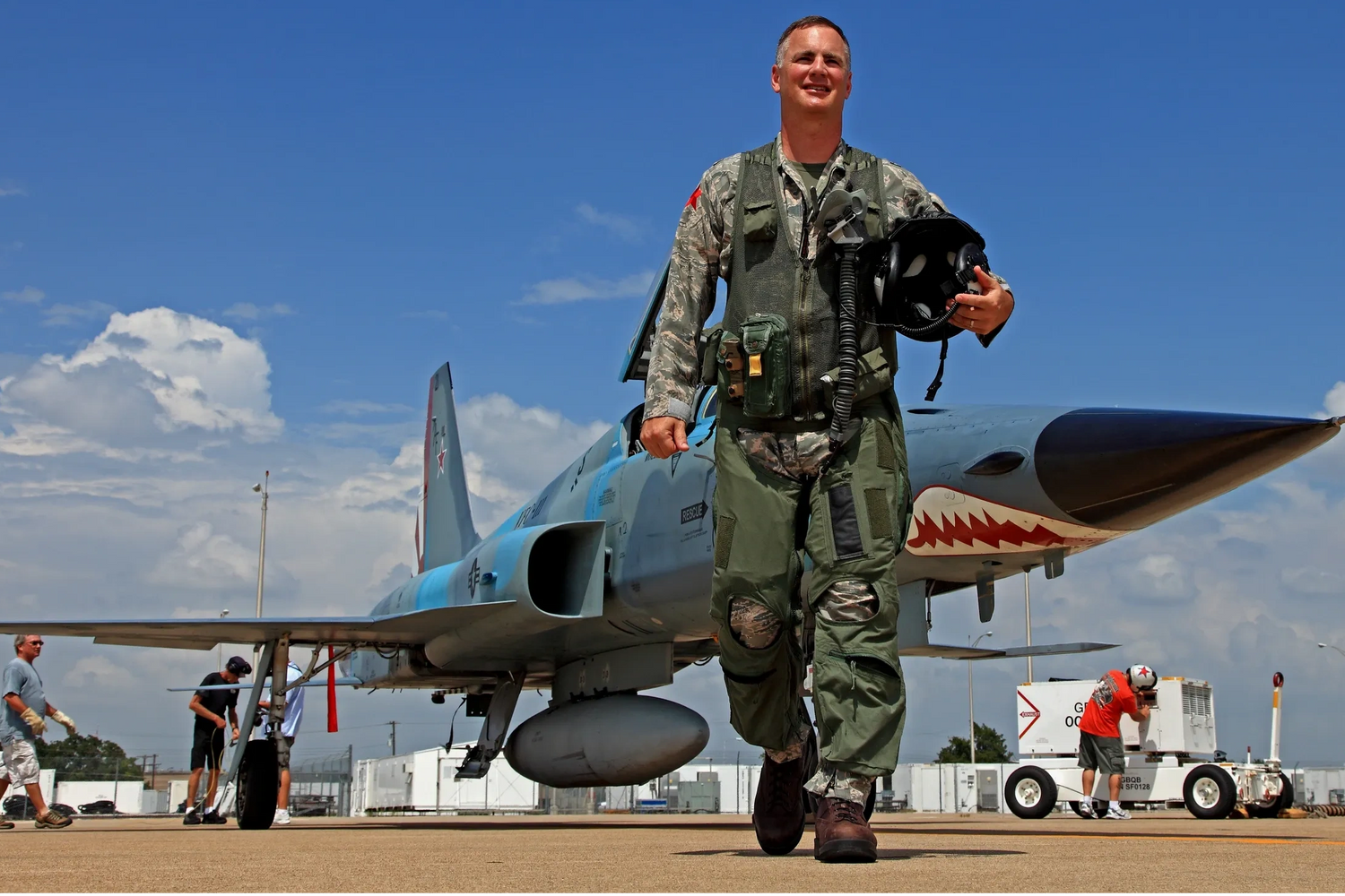 John "Bag" Hefti, walking in front of an F-5 Tiger airplane.