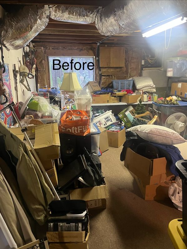 Cluttered basement storage with boxes and household items.