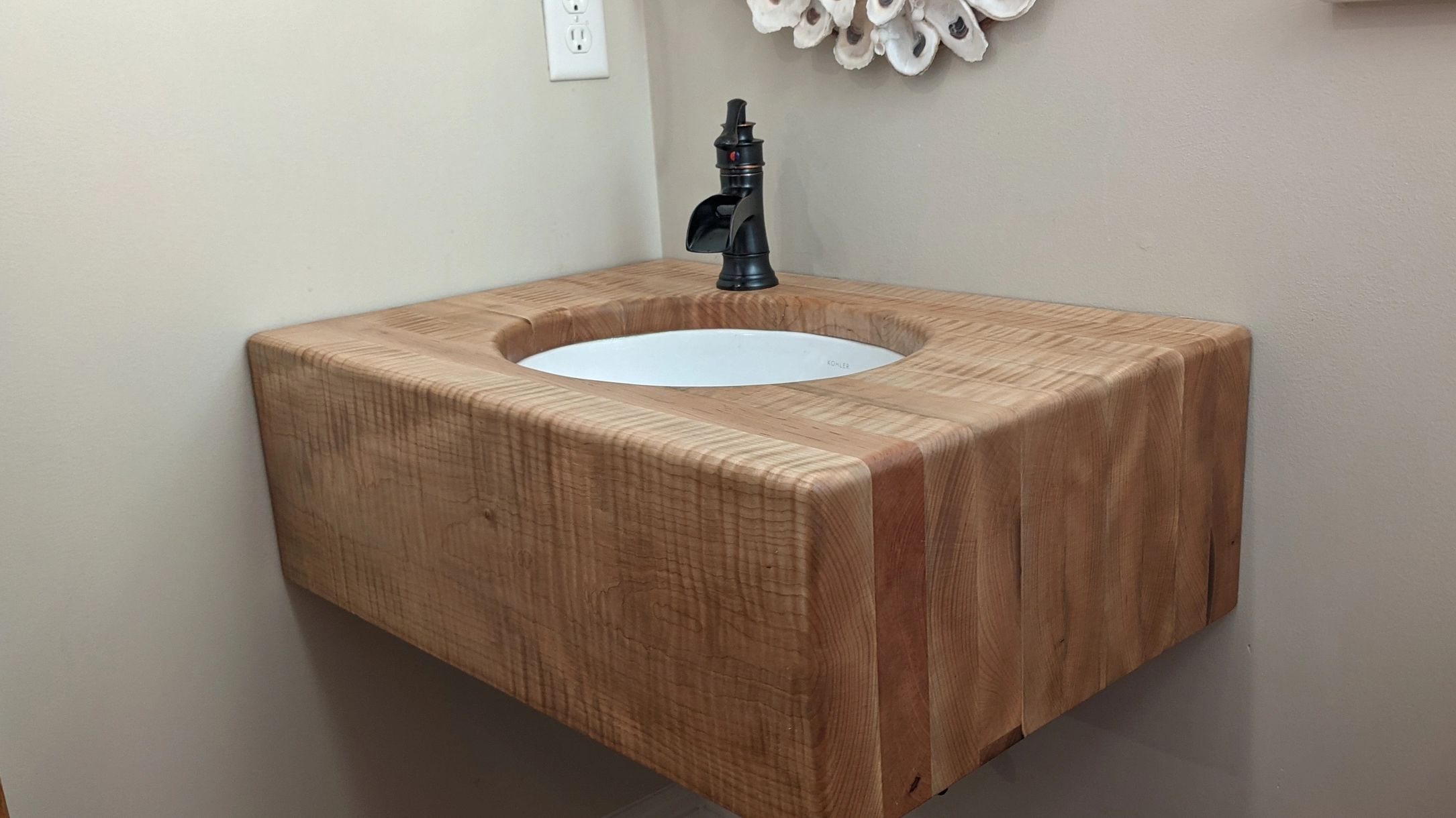 Tiger maple floating corner mounted vanity with undermount sink