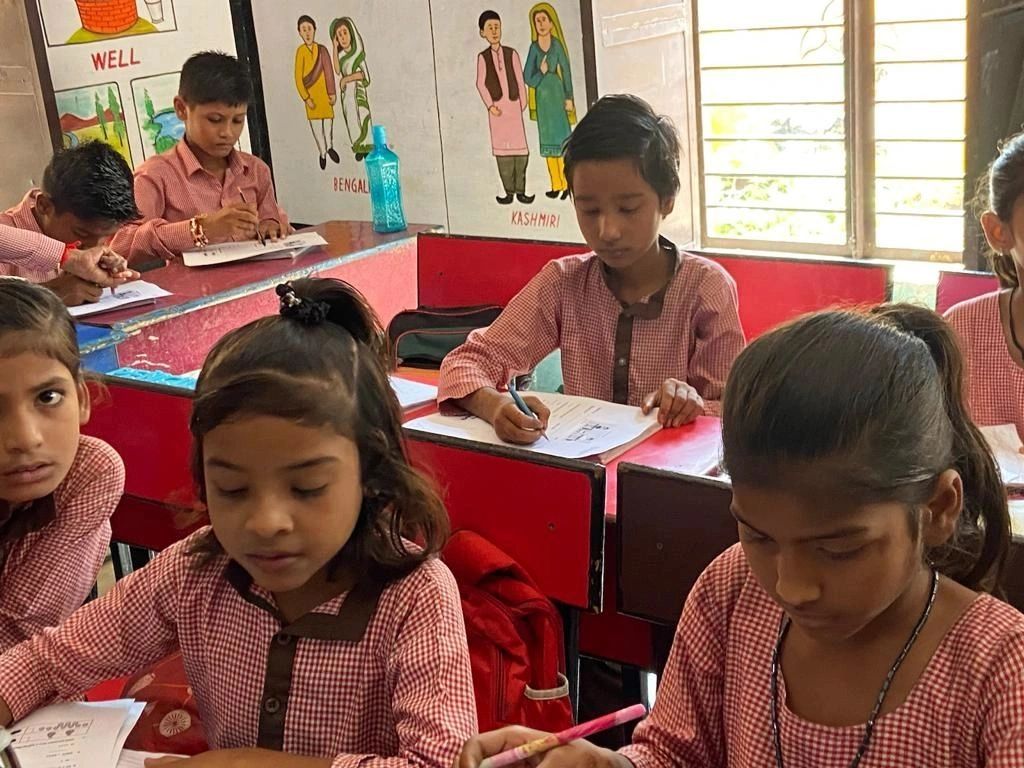 Children in a classroom working on assignments.