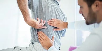 Patient is being examined for a spinal tumor by a neurosurgeon.