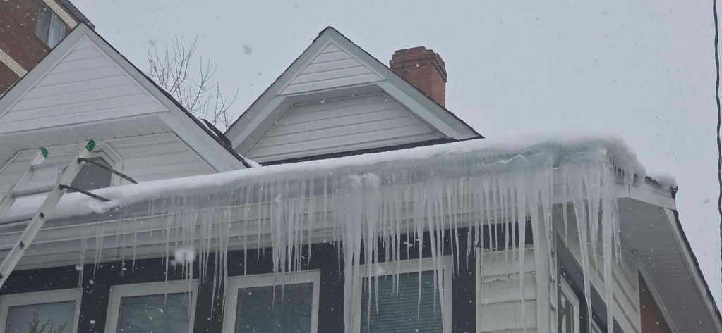 ice dam removal and build up on shingles and trough.