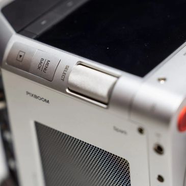 Close-up of dial and buttons on a silver electronic device.