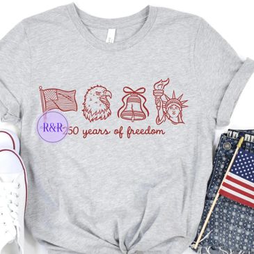 Gray t-shirt celebrating 250 years of American freedom with patriotic symbols.