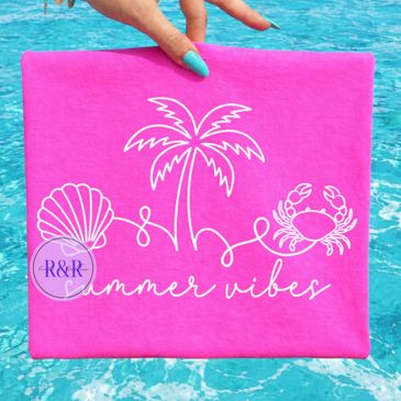 Bright pink pouch with summer-themed white designs held over a pool.