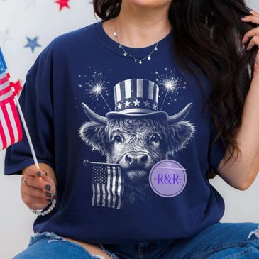 Person wearing a patriotic shirt with a cow in a Uncle Sam hat holding an American flag.